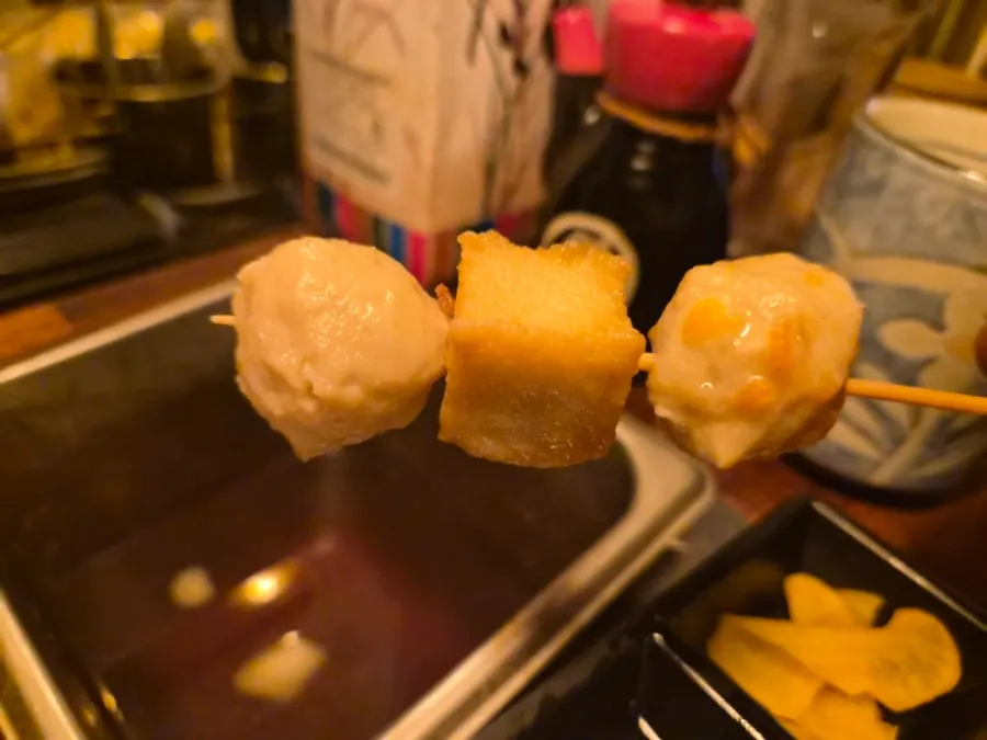 Curly fish cake dipped in soy sauce