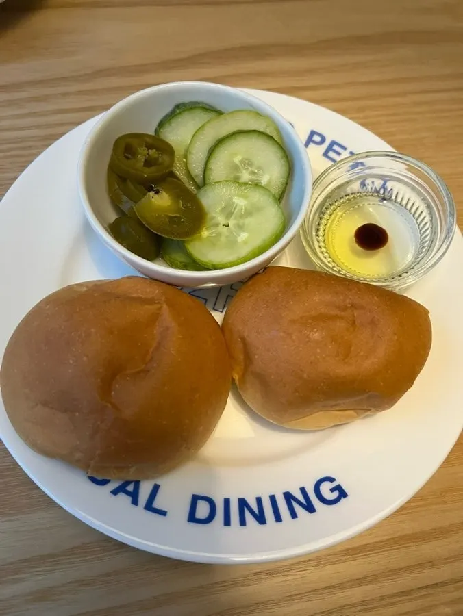 Pre-meal bread with morning rolls, pickles, and jalapeños