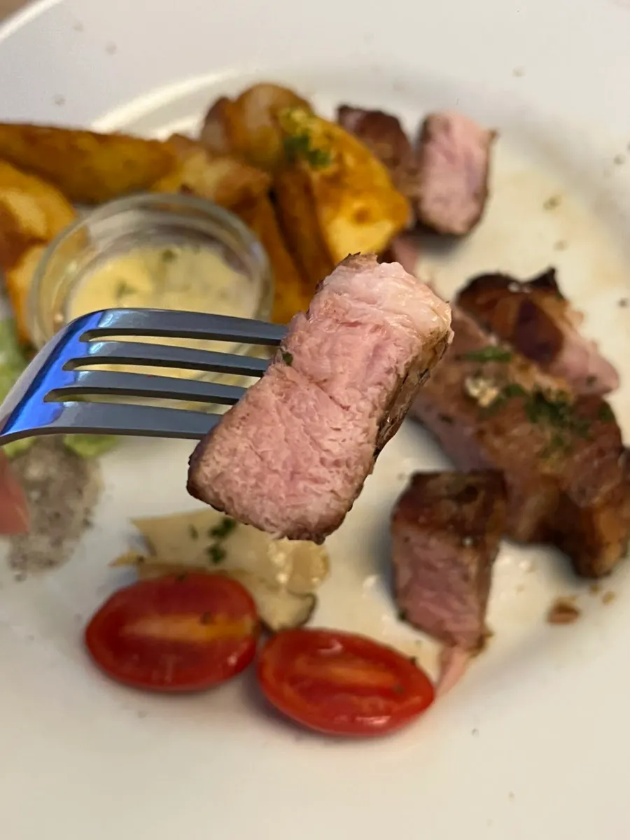 A piece of sous-vide pork neck with sauce