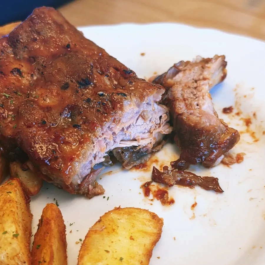 BBQ pork ribs being eaten by holding the bone