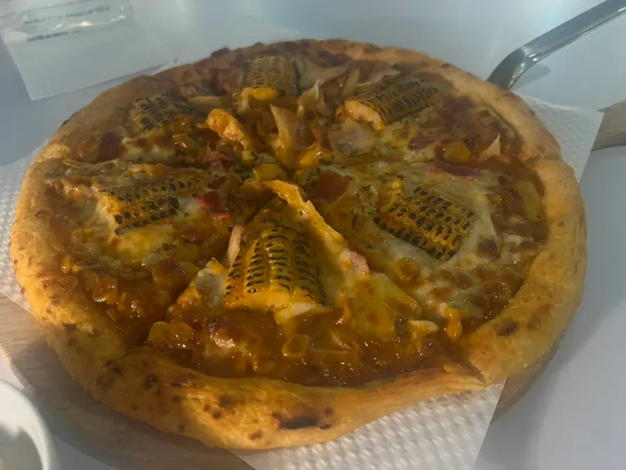 Corn pizza topped with flame-charred corn