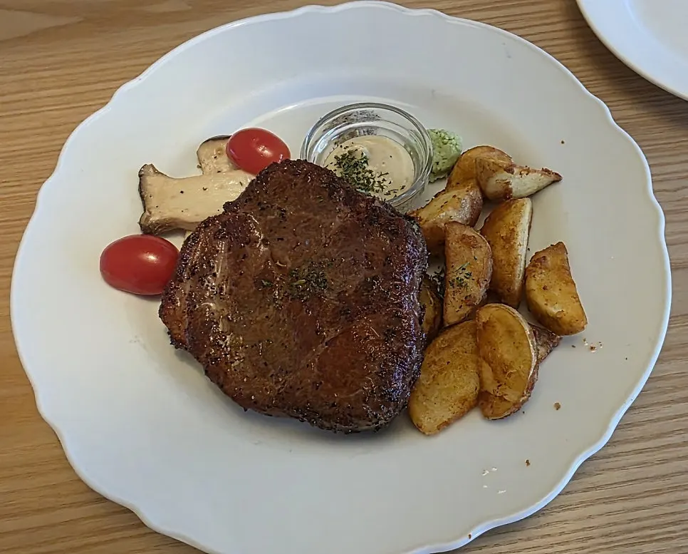 Plate of sous-vide pork neck with a moist cross-section