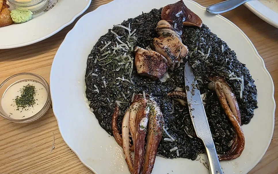 Close-up of the squid ink risotto with whole squid
