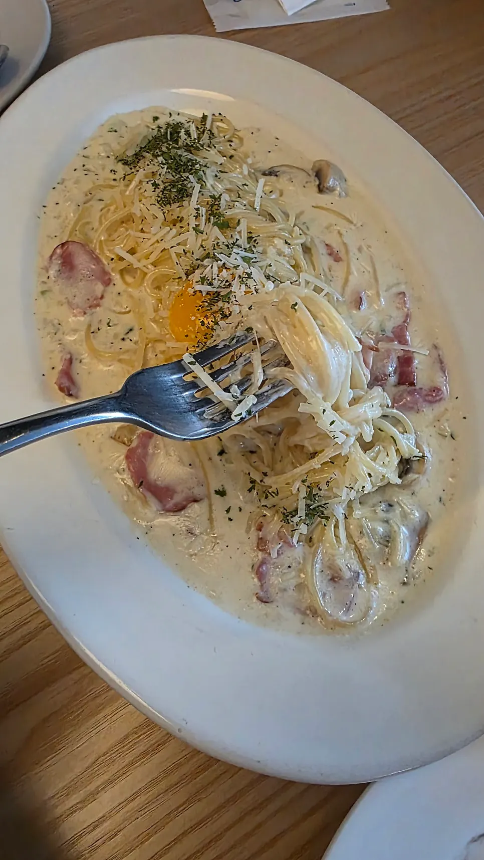 Carbonara topped with bacon and egg