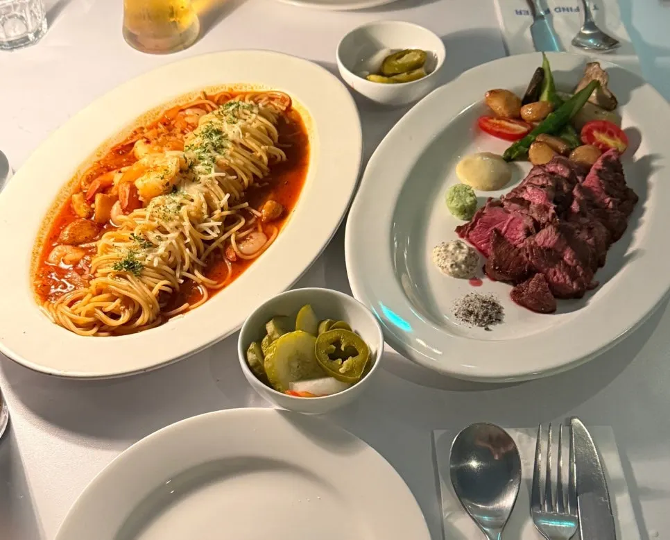 Pasta and steak served together on the table