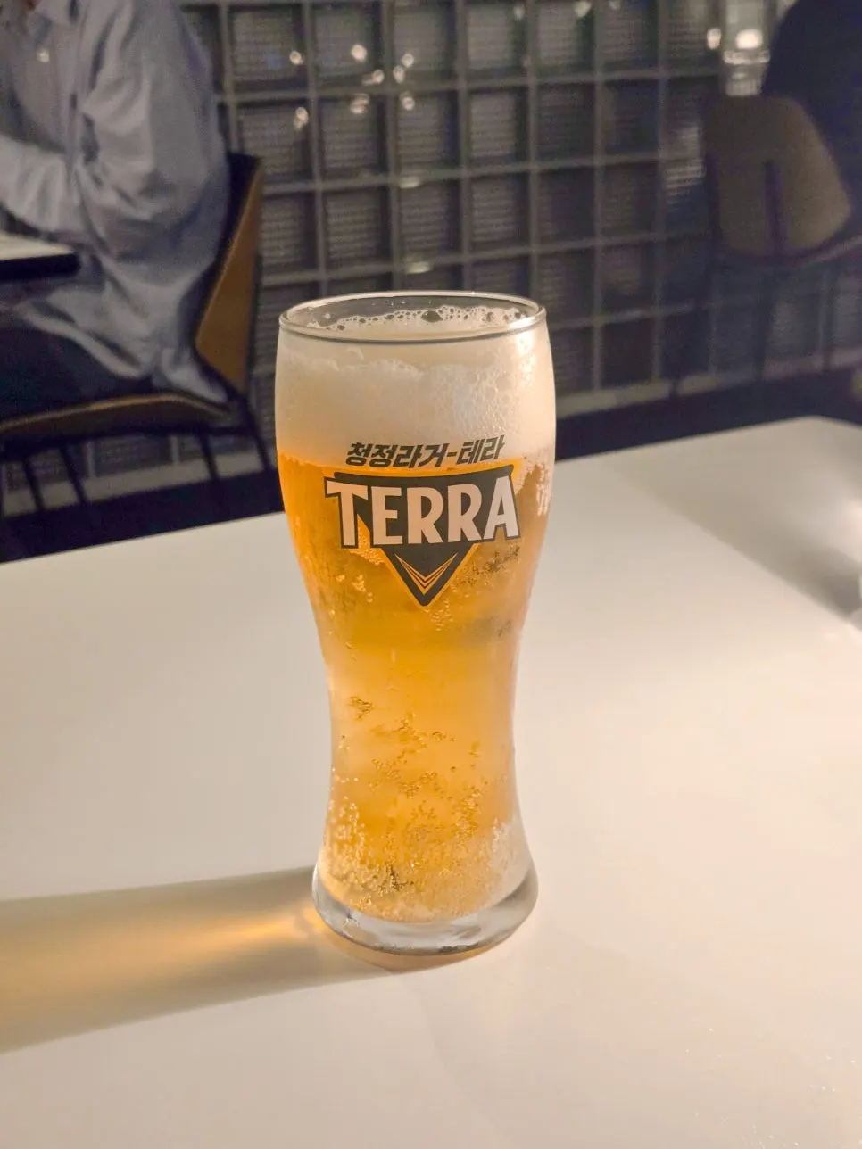 A glass of draft beer served with the pasta