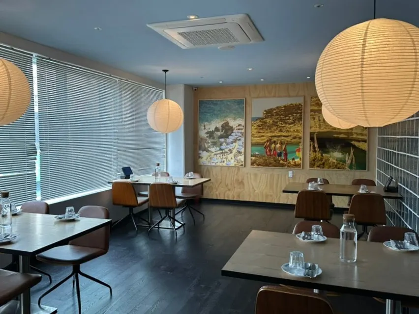Spaciously arranged tables and brown chairs