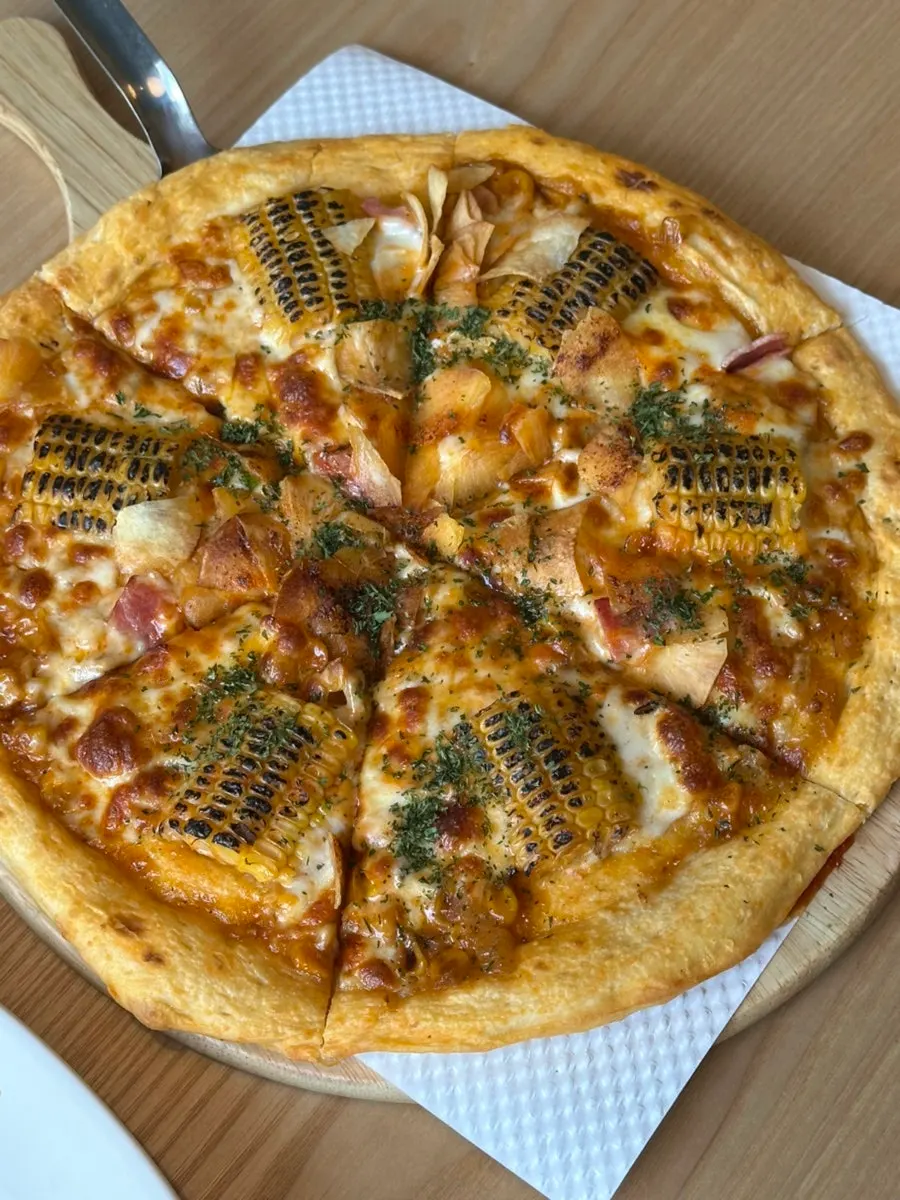 Whole corn pizza served alongside the pasta
