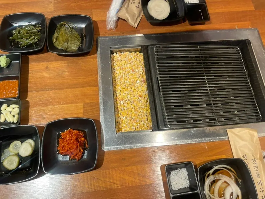 A spread of various side dishes served with the meat