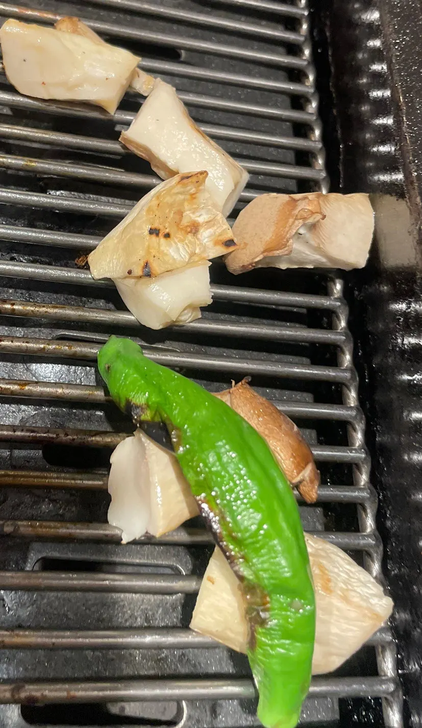 Vertical shot of meat grilling on the pan