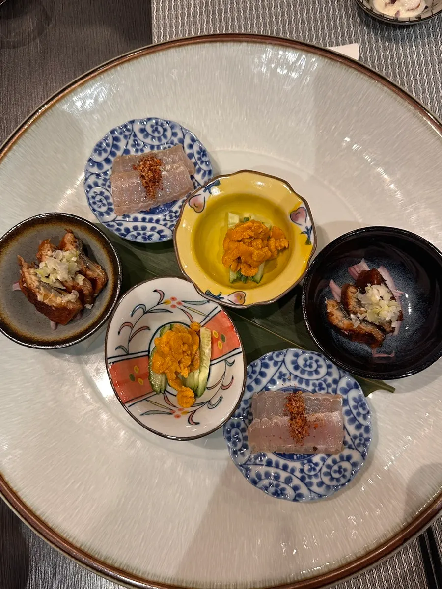 One-piece servings of flounder sashimi, squid, and salmon