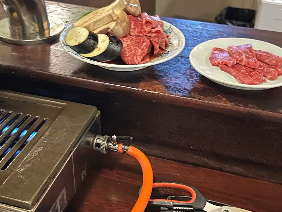 El personal asando la carne en la parrilla