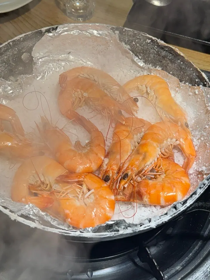 Grilled salt shrimp cooked on a bed of salt