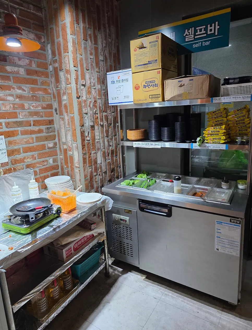 Self-serve bar with instant noodle add-ons and kimchi pancake ingredients