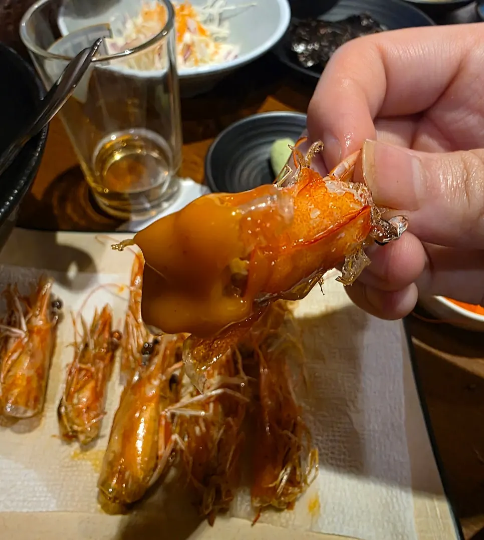 Grilled shrimp heads served alongside the sashimi