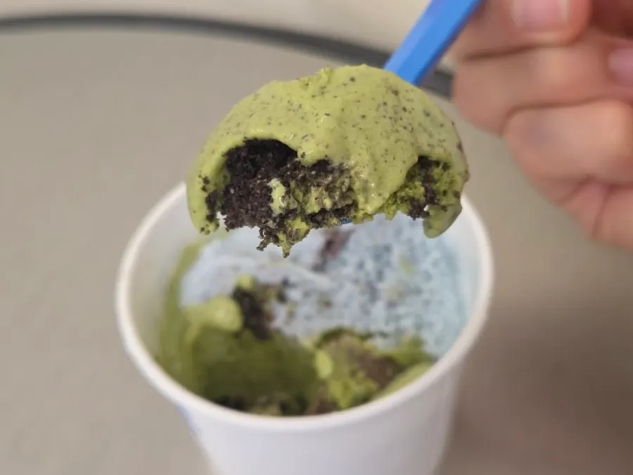 Ice cream cup half eaten, revealing the matcha layer