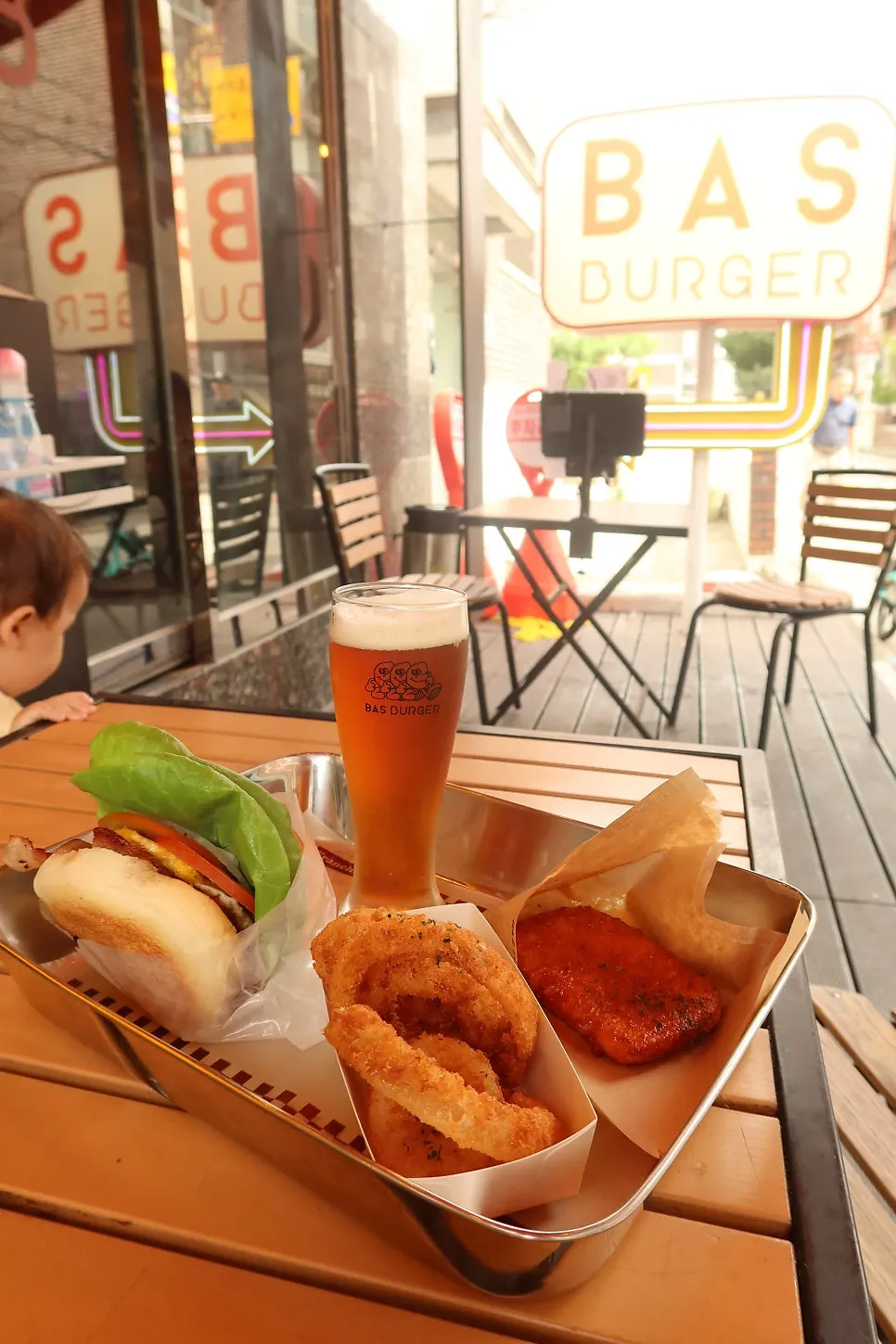 Table spread with the Tamyok Burger and side dishes