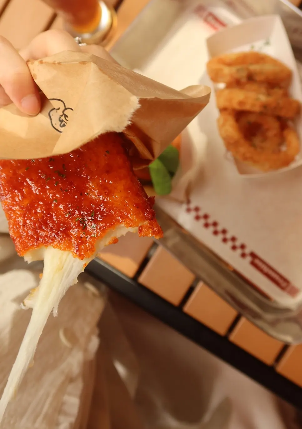 Cheese stretching from the chili mozza cheese bar