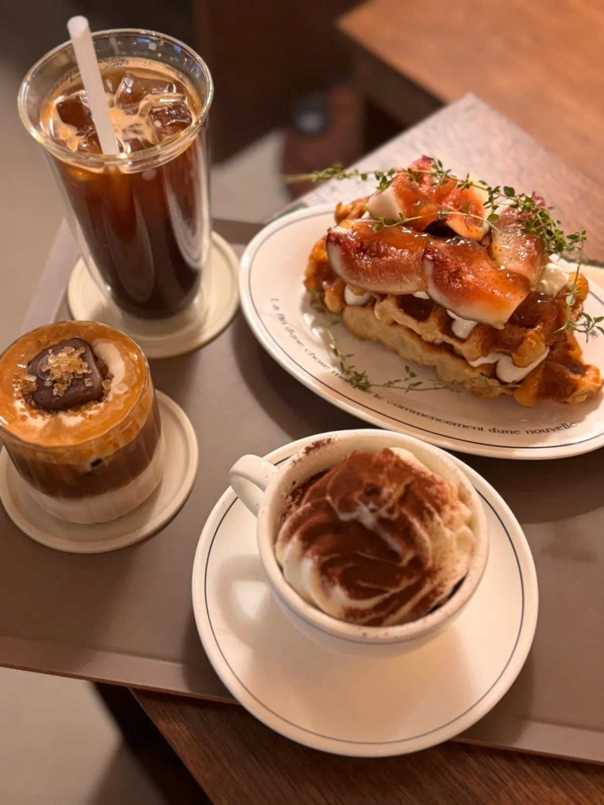 Desserts and drinks on a wood-toned table at Biat Seongsu