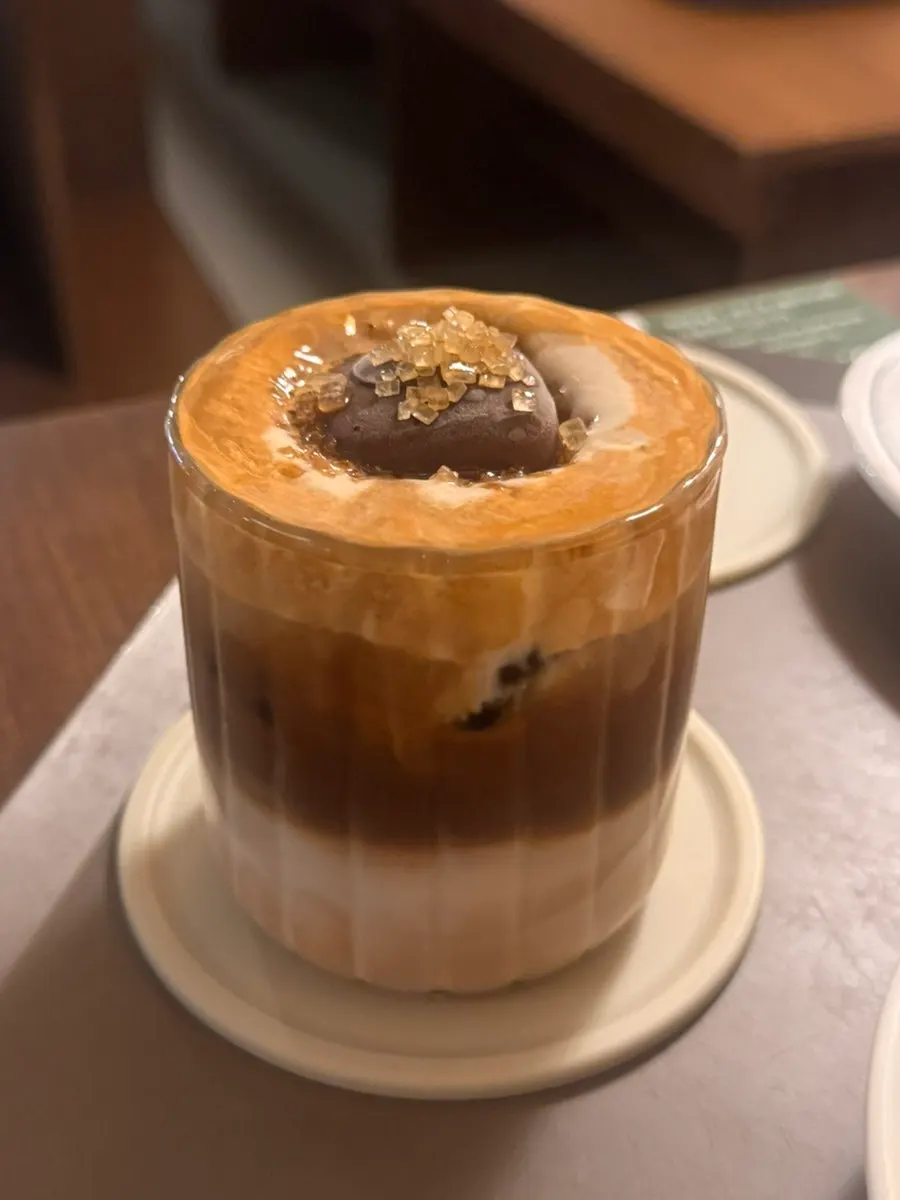A spoonful of tiramisu affogato with soft serve on top