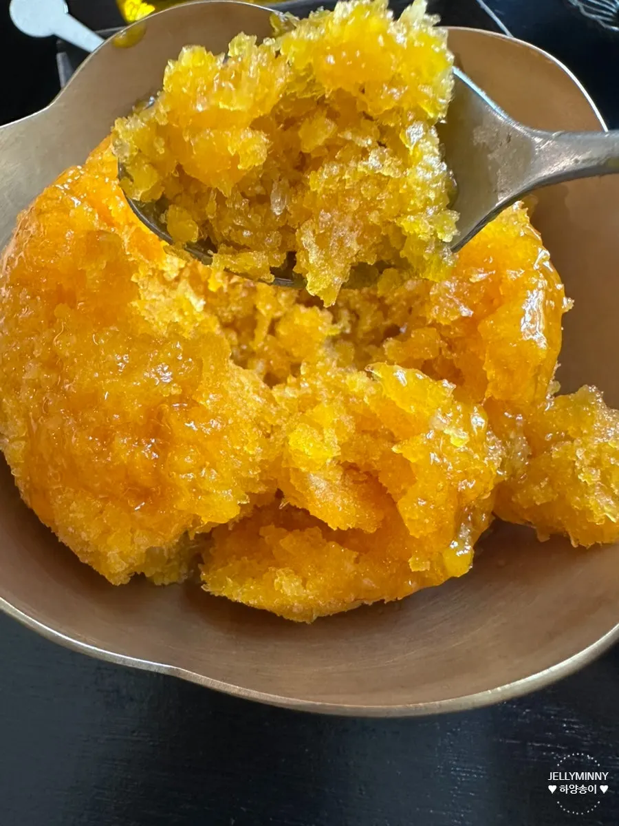 A spoonful of pumpkin bingsu scooped up
