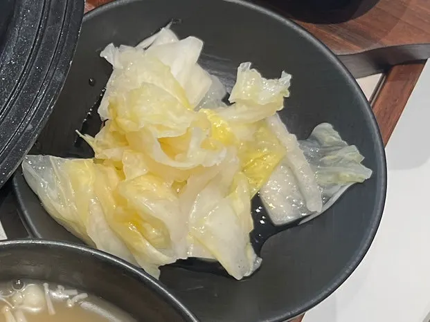 Cut tteokgalbi cross-section with a side of baek-kimchi