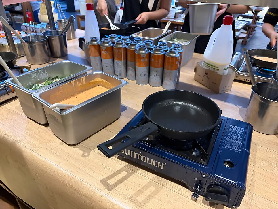 Biniljip self-serve corner with vegetables, side dishes, and sauces
