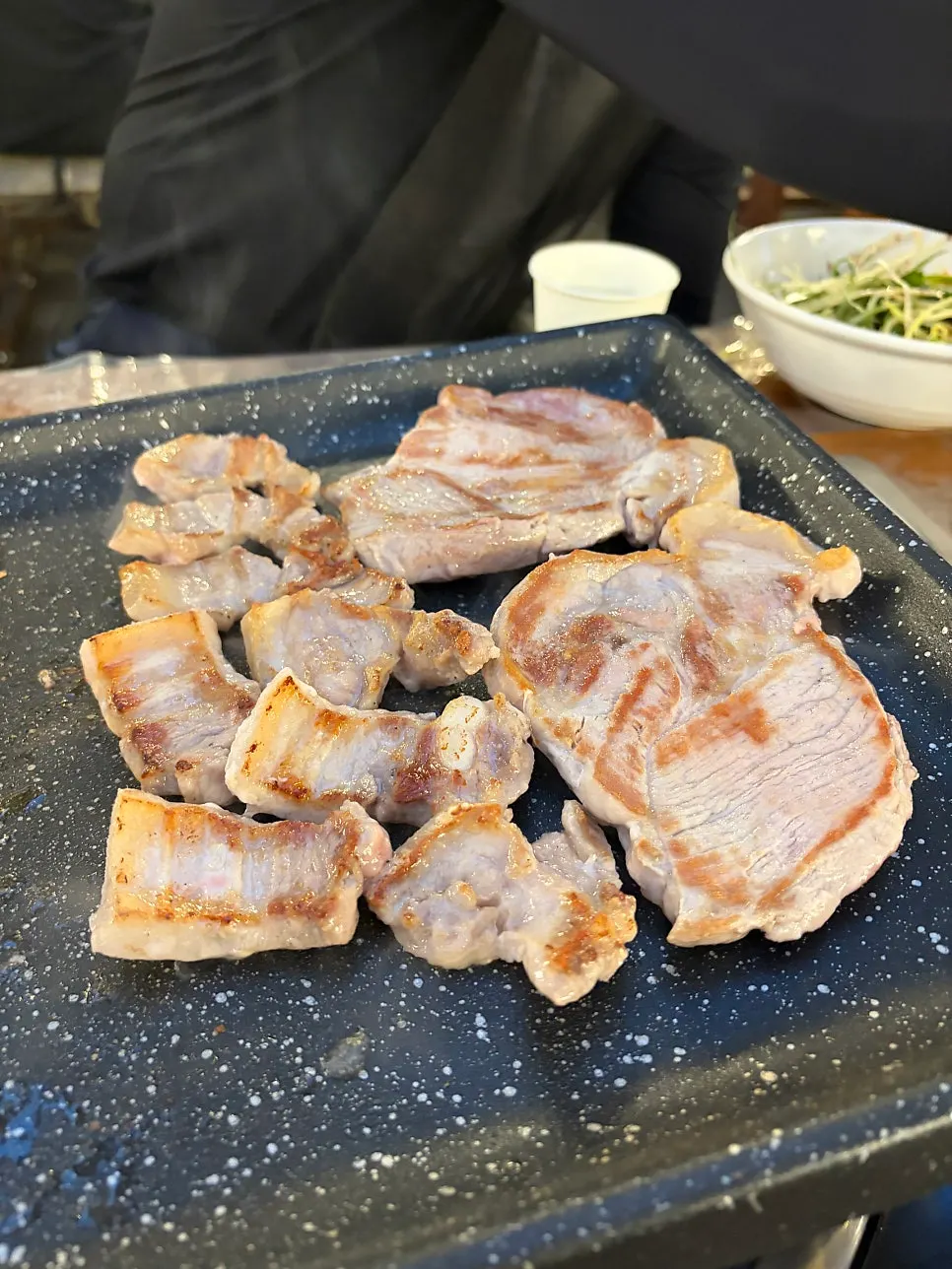 Pork belly grilling on the pan