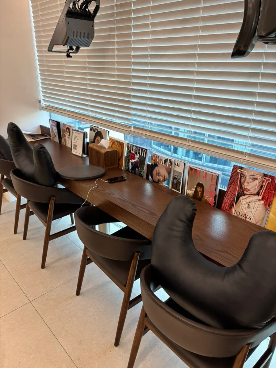 Salon interior with large windows letting in natural light