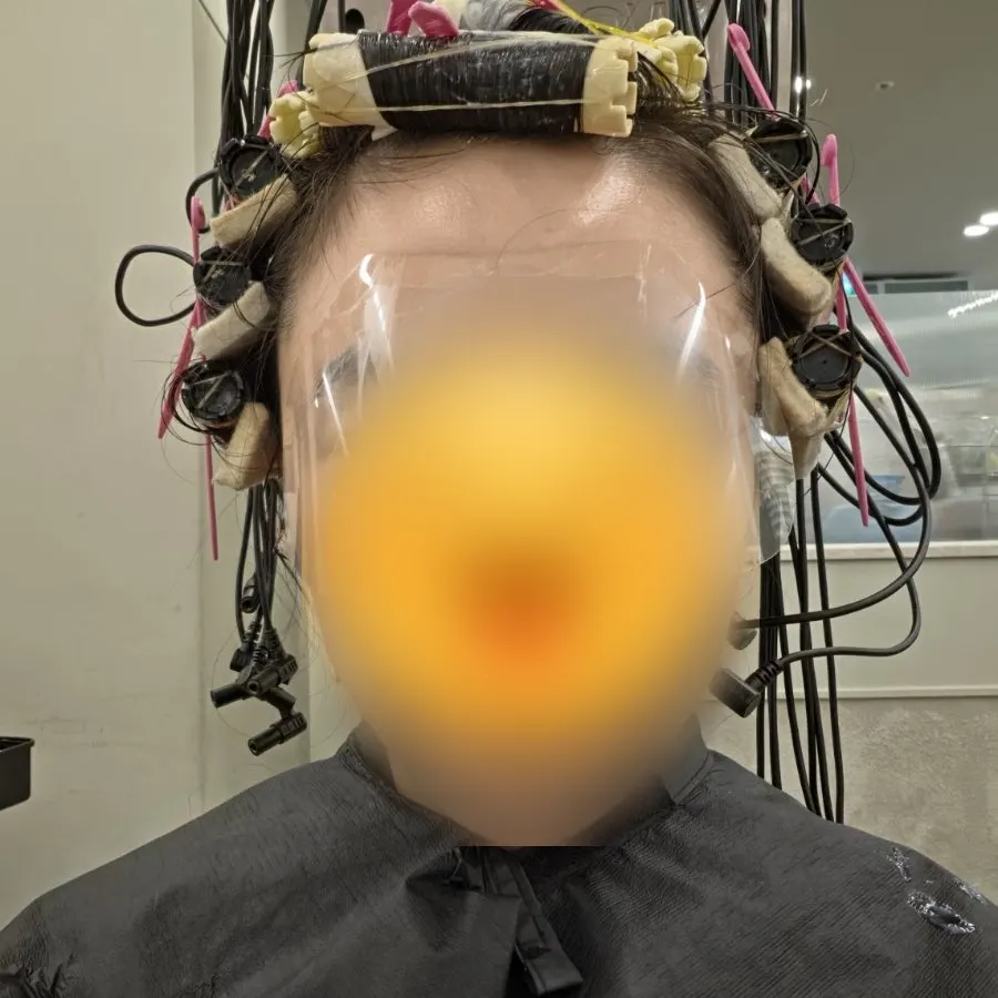 Long hair wound with perm rolls