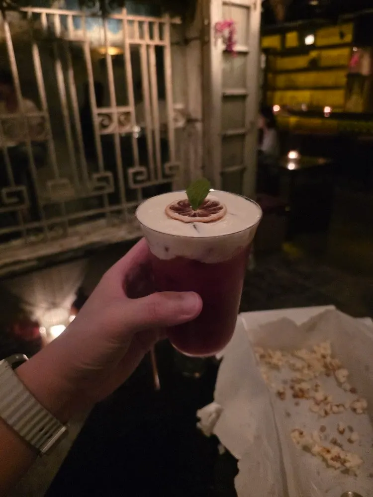 A bartender mixing cocktails at Birdman's bar table