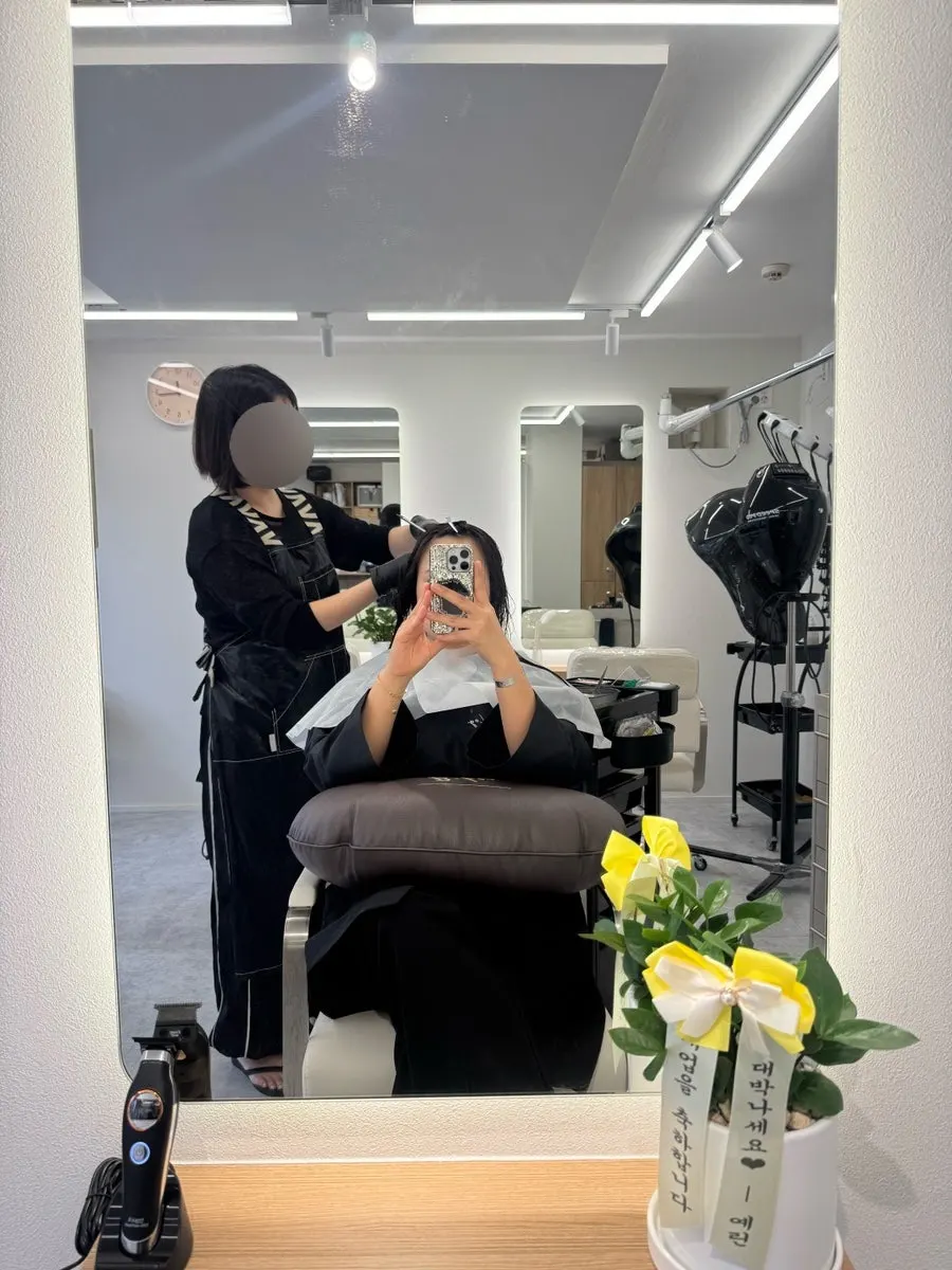 Consultation scene checking hair condition before the straight perm
