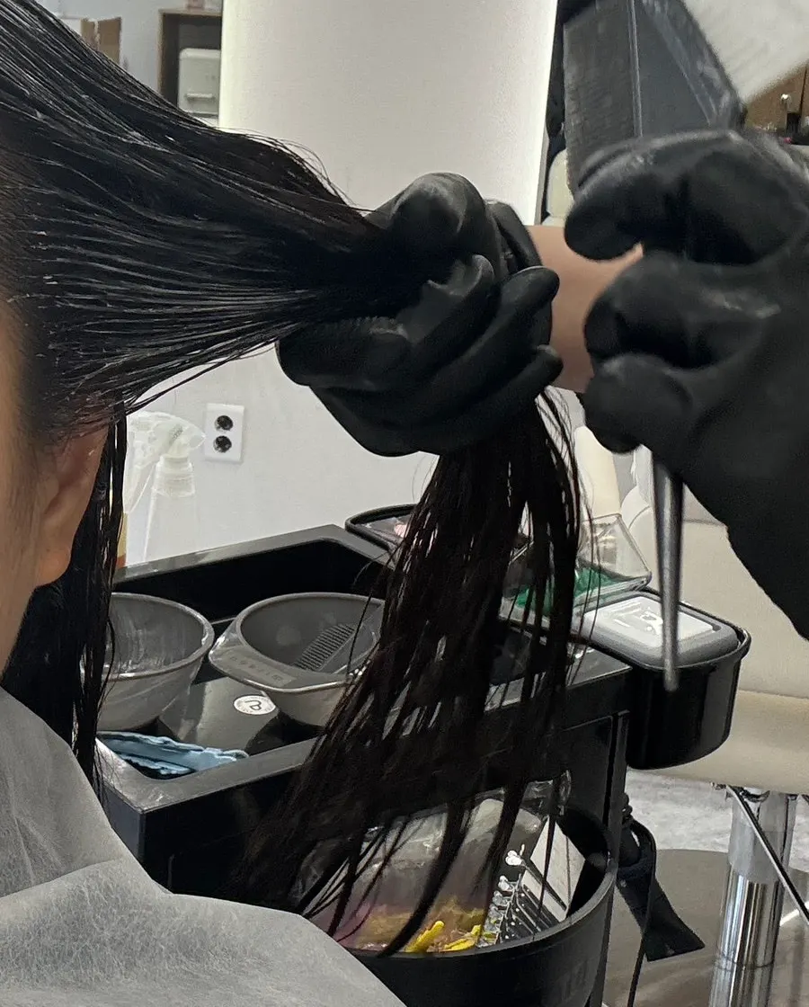 Hair sectioned before starting the straight perm treatment