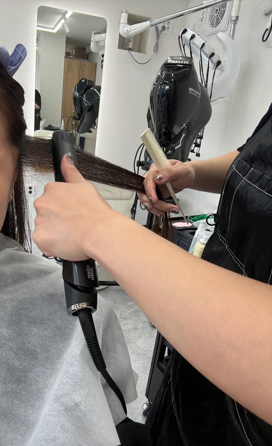 Using a heating iron to straighten the hair