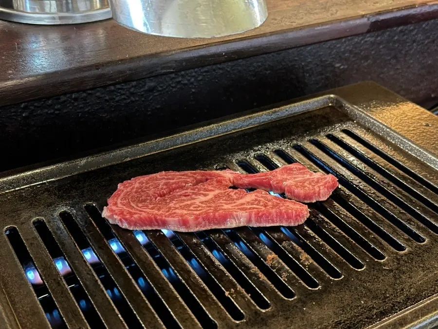 직원이 화로에 구워준 새우살 한 점