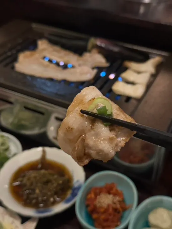 A piece of meat served with grilled vegetables
