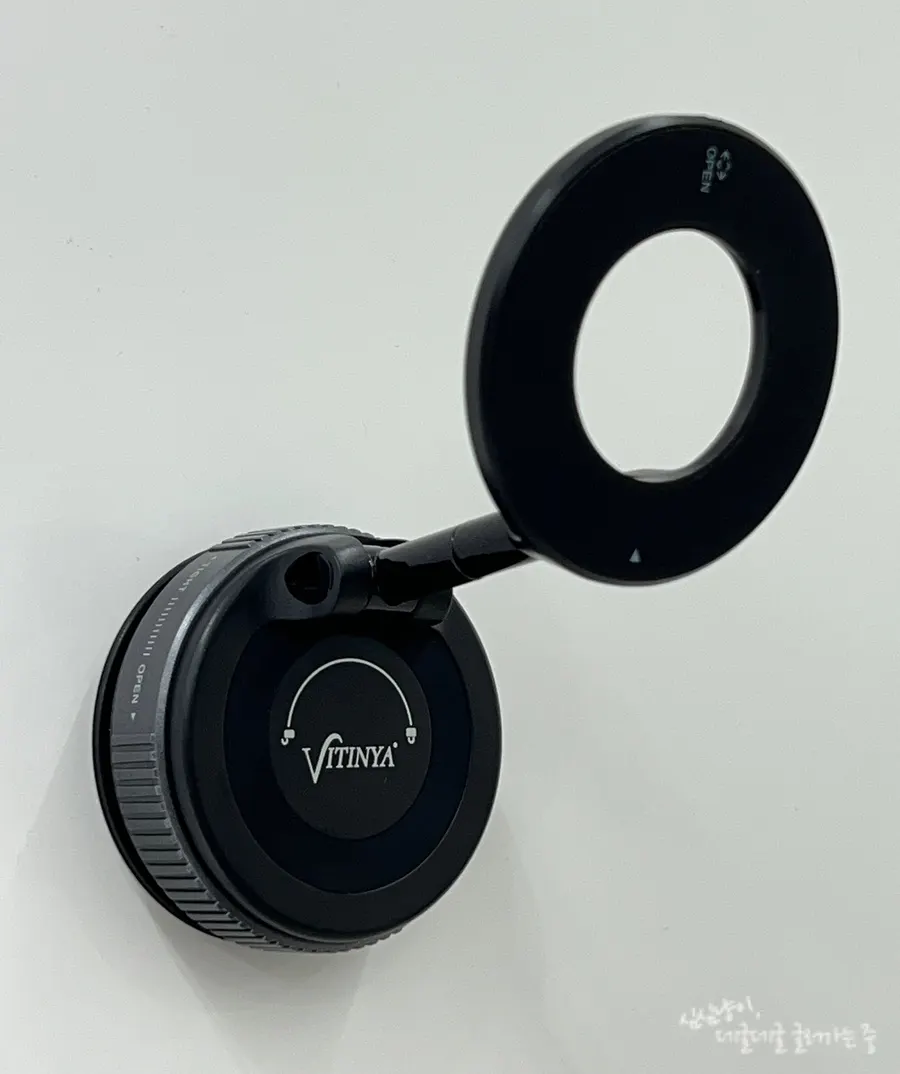Phone holder attached to an upper kitchen cabinet door