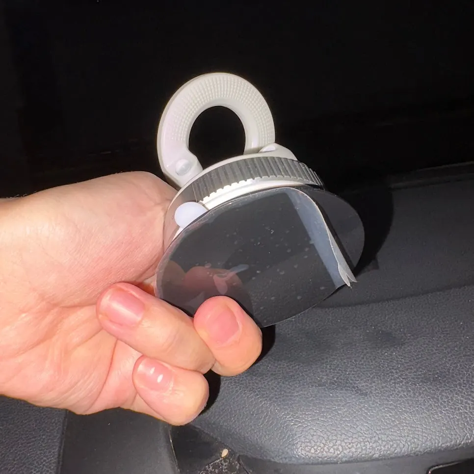 Preparing the suction pad before attaching it inside the car
