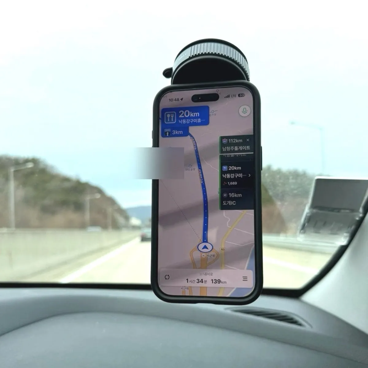 Bitnya phone mount attached to a car window