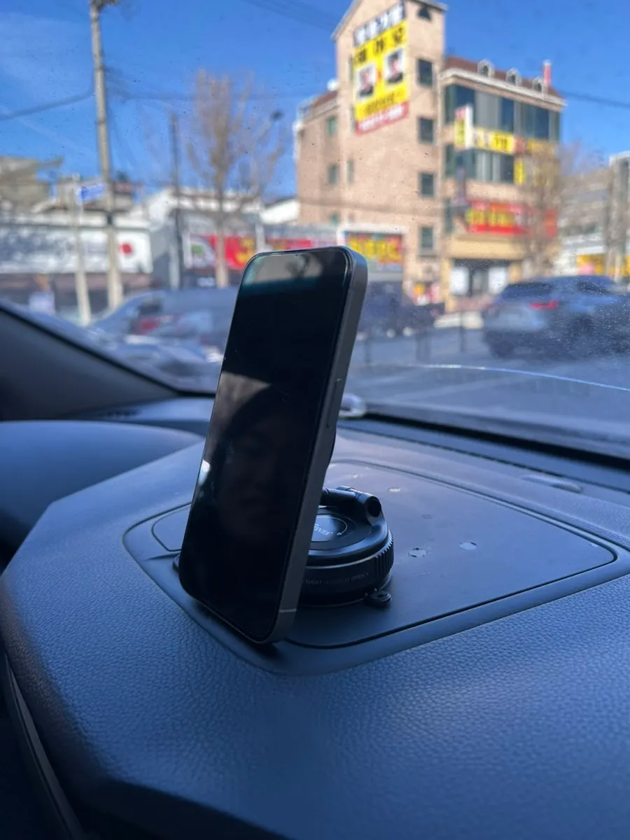 Phone mount attached to a flat surface in a car