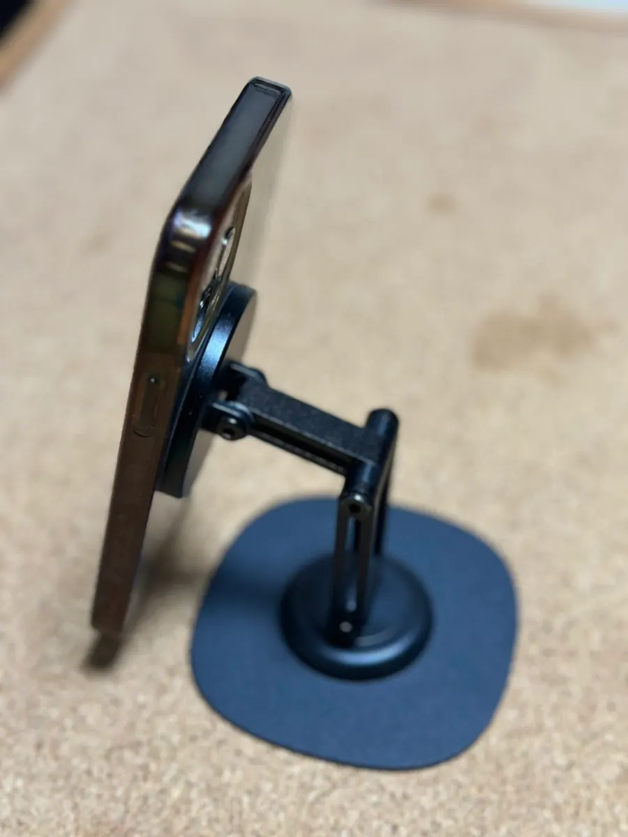 Phone stand holding a phone in place with a magnet