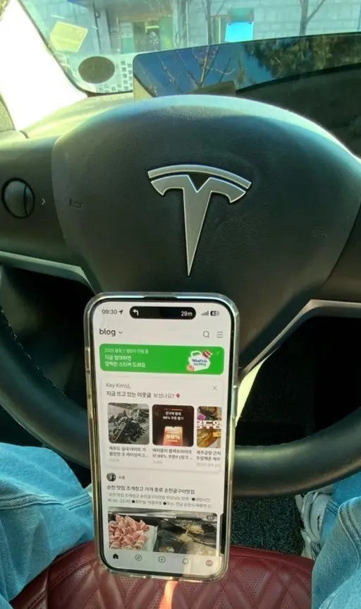 Smartphone mounted below the steering wheel for work