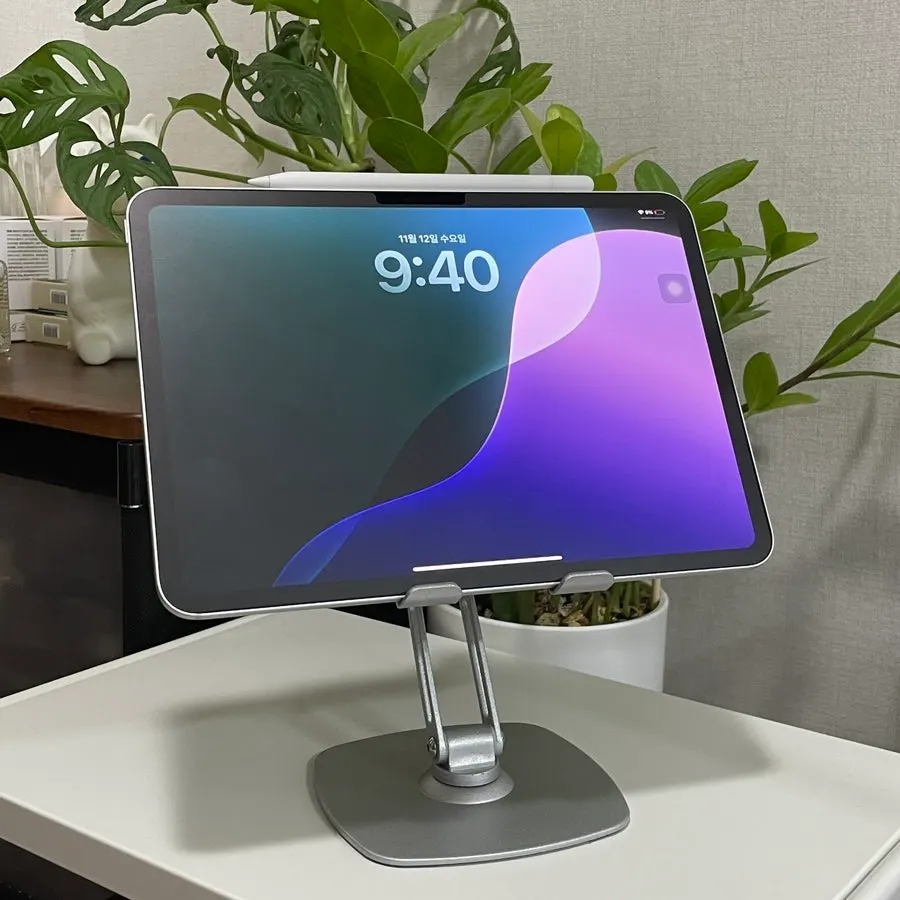 Tablet stand in use with the height adjusted