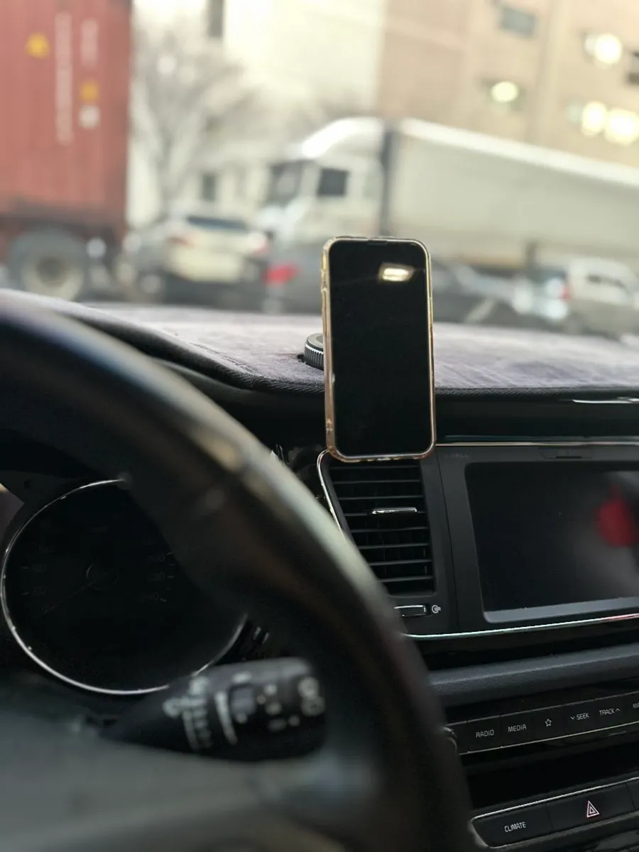 Car phone mount holding an iPhone 13 mini