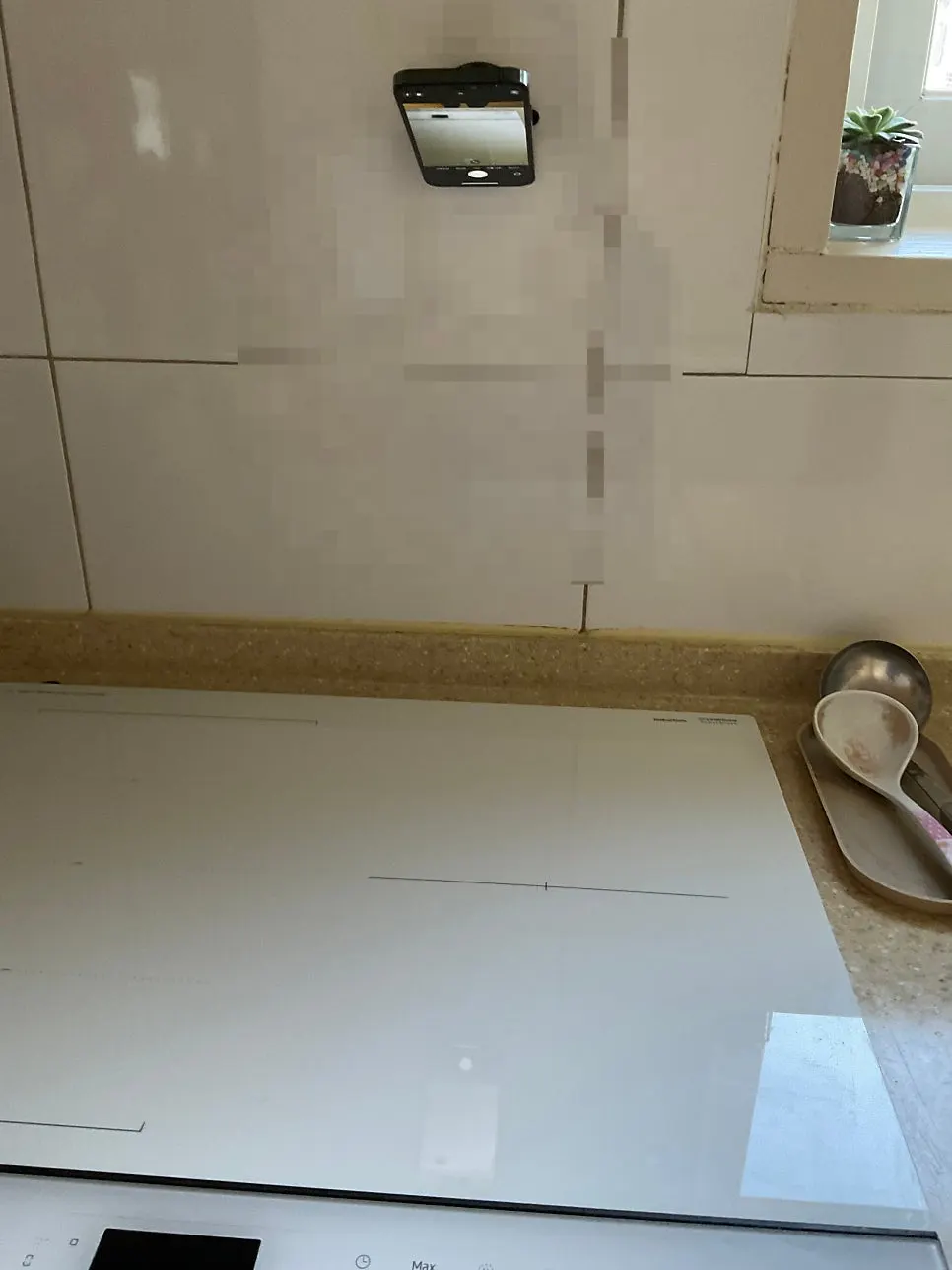 Phone mount attached to a kitchen wall