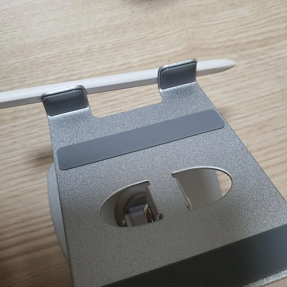 Tablet stand with a charging-port opening