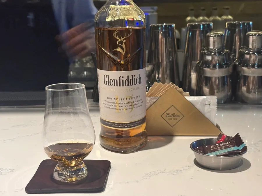 A gin tonic and a glass of Glenfiddich 15