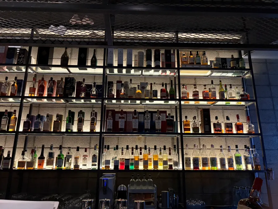 The bottle display seen from the bar seats