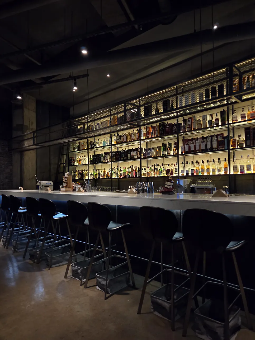 Interior of Bitters with dim lighting and bottles on display