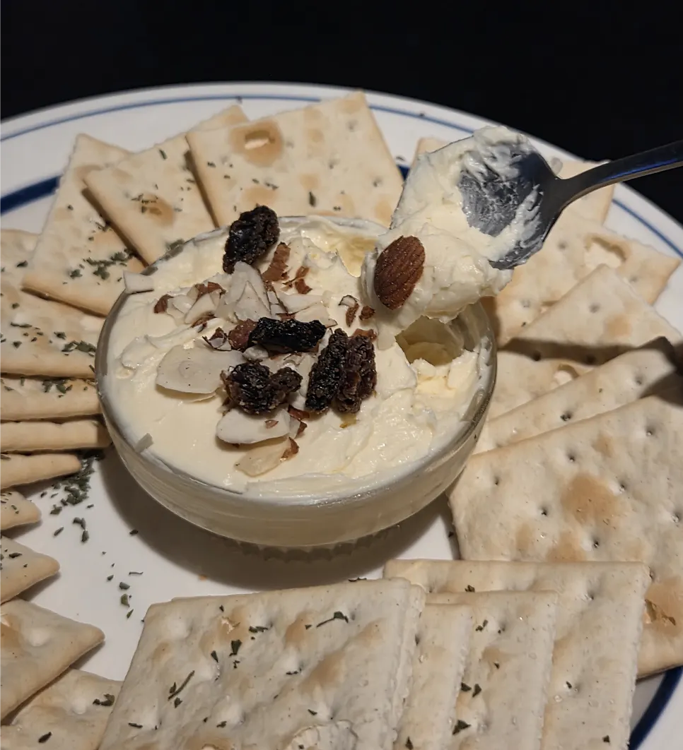 Close-up of a cracker topped with cream cheese